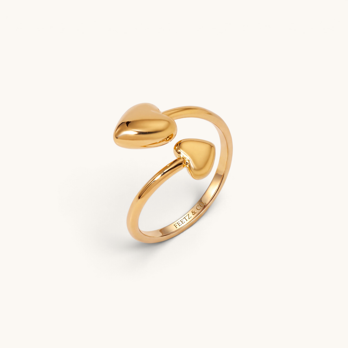 Feetz & Co. Adore adjustable gold stainless steel toe ring featuring two polished heart charms on an open band.