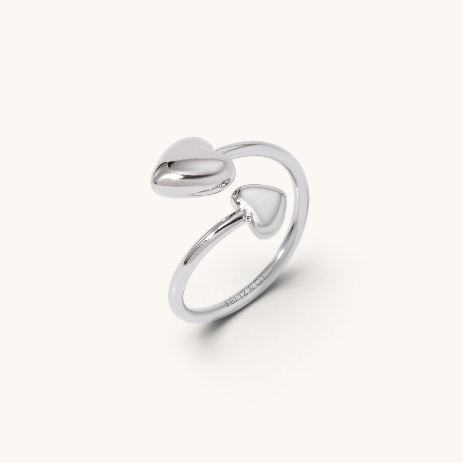 Feetz & Co. silver adjustable toe ring featuring two polished heart charms in an open band design.