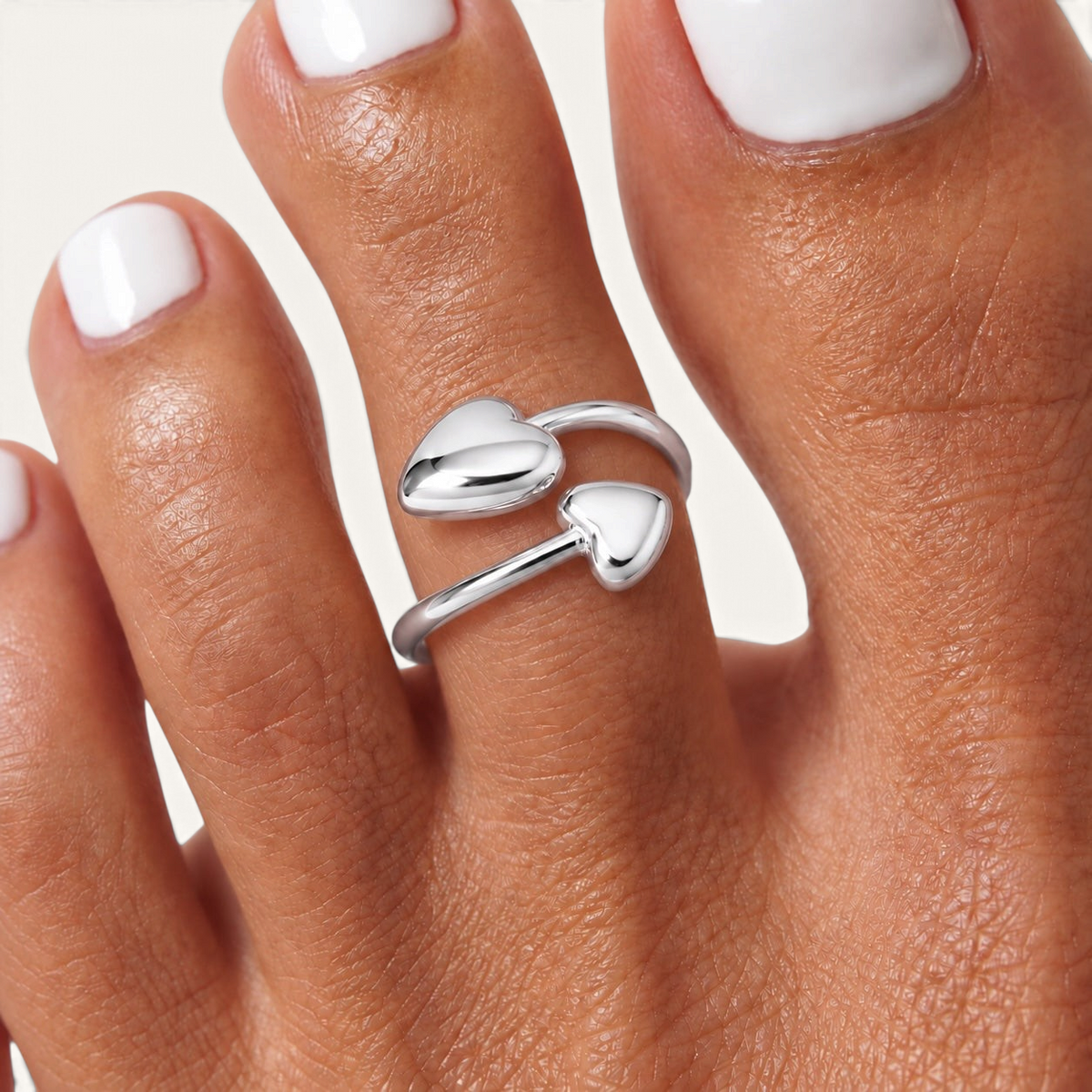 Feetz & Co. Adore adjustable silver toe ring featuring two polished heart charms on a sleek open band