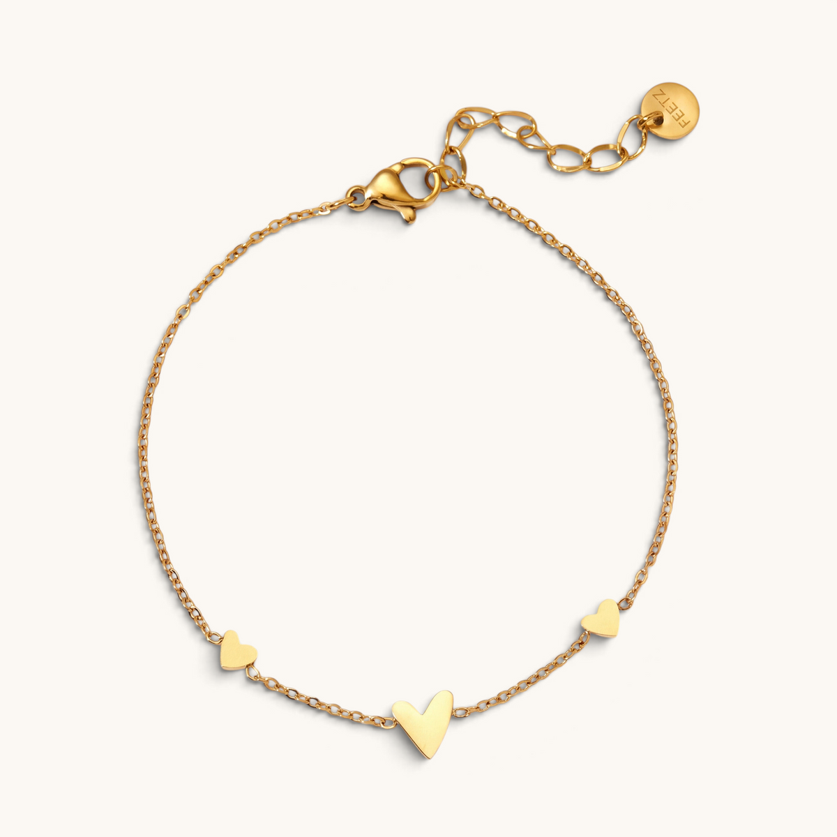Feetz & Co. Amore gold-tone stainless steel anklet featuring three delicate heart charms on a fine cable chain.