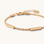 Feetz & Co. Asta anklet featuring polished gold-tone stainless steel bars on a delicate twisted chain