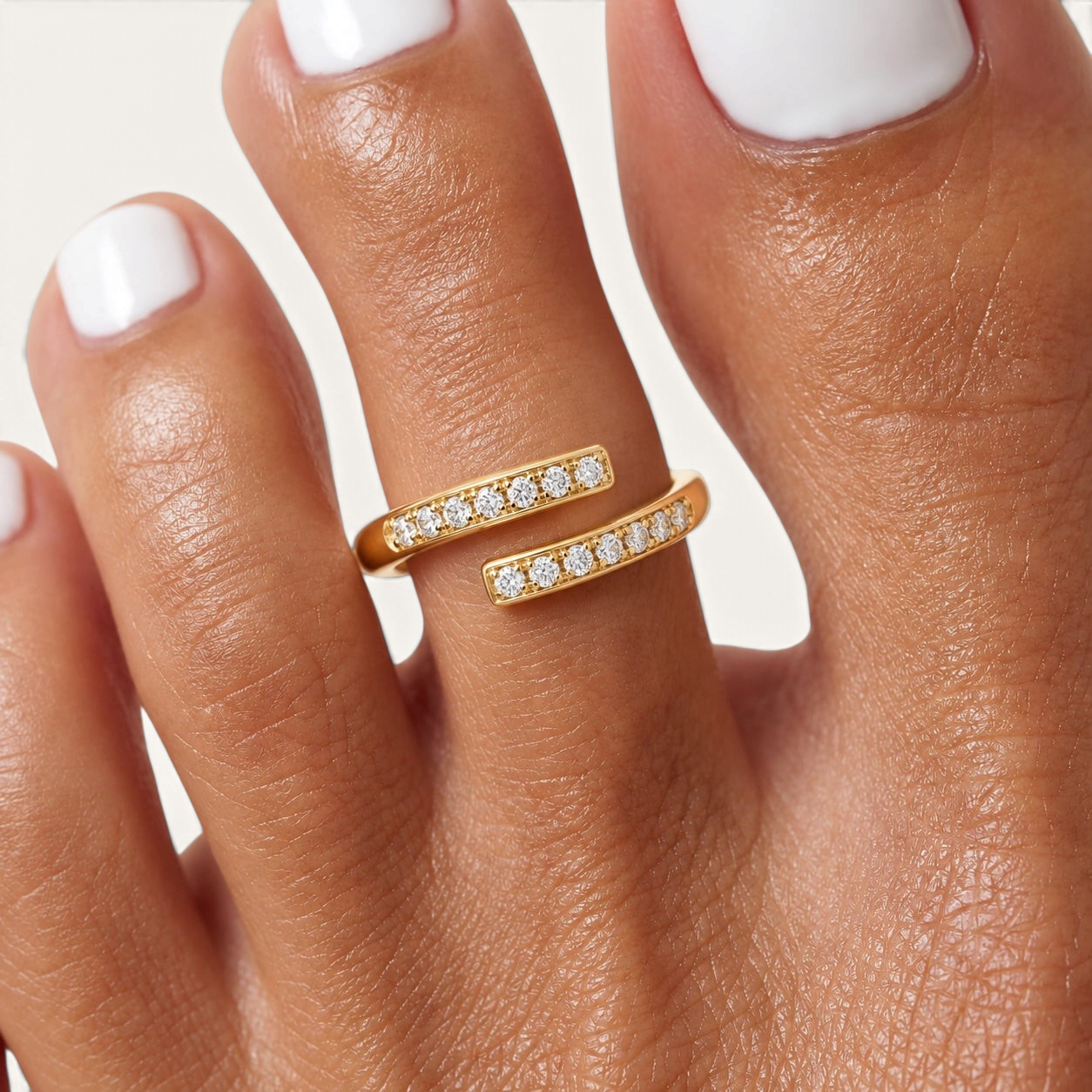 Feetz & Co. gold adjustable toe ring featuring two rows of sparkling stones on a polished stainless steel band.