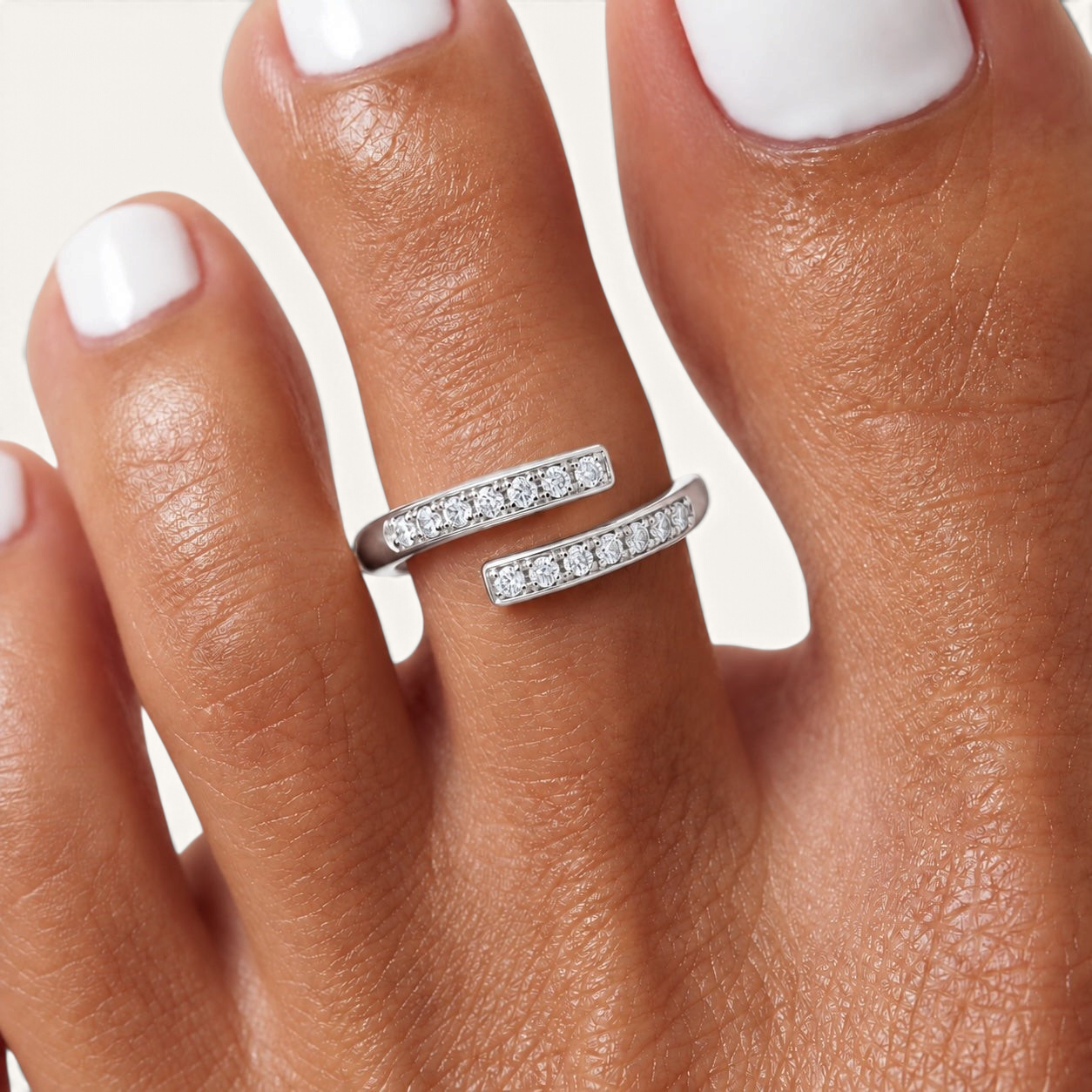Feetz & Co. DUET adjustable silver-tone stainless steel toe ring with two rows of sparkling stones on a foot.