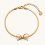 Feetz & Co. Eterna gold herringbone chain anklet featuring a delicate bow charm and adjustable lobster clasp closure.