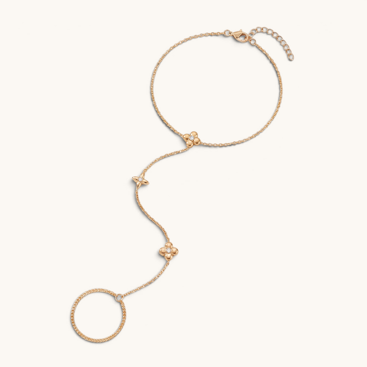 Feetz & Co. gold stainless steel barefoot sandal featuring delicate flower charms with clear stones and a toe loop.