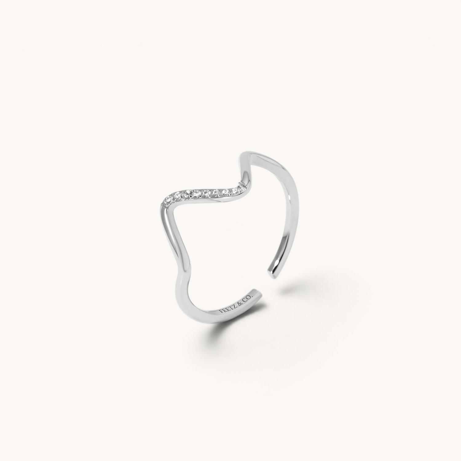 Feetz & Co. silver wave-shaped adjustable toe ring in polished stainless steel with a line of sparkling stones.