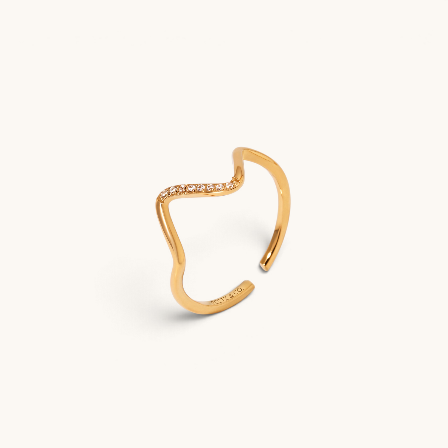 Feetz & Co. gold adjustable toe ring featuring a delicate wave design with a row of sparkling stones.