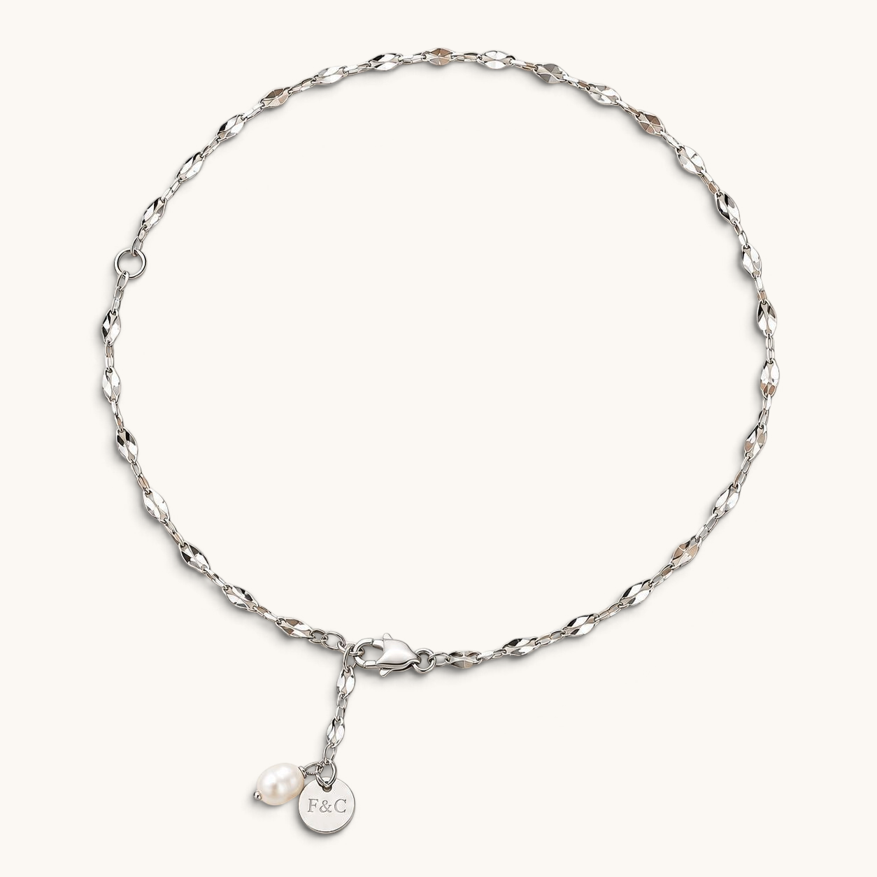 Feetz & Co. Pia anklet featuring a delicate silver-plated stainless steel chain with a freshwater pearl drop charm.