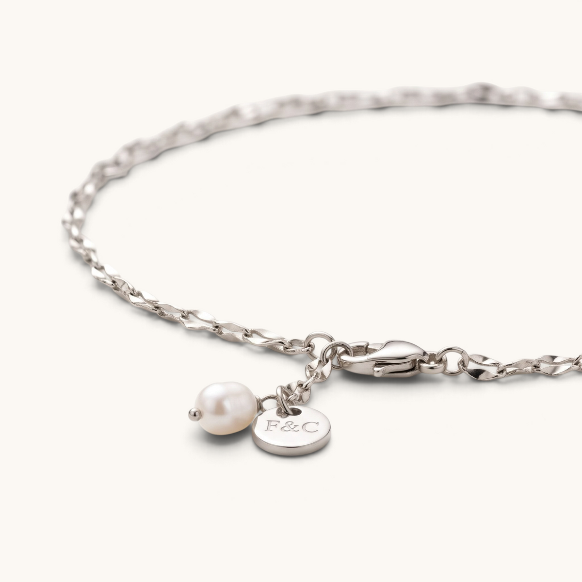 Feetz & Co. Pia anklet featuring a delicate silver-plated stainless steel chain with a freshwater pearl drop charm.