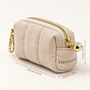 Feetz & Co. beige quilted suede-feel puffy pouch with a gold zipper and clip for keys or bags.