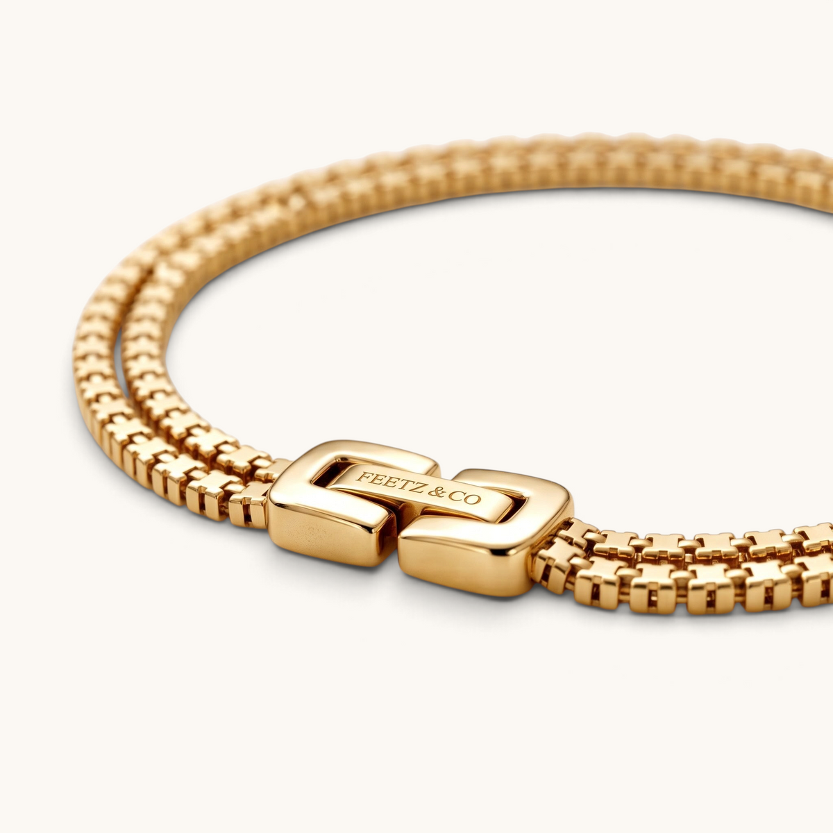 Feetz & Co. Rhea anklet featuring two parallel rows of gold-plated box links with a branded polished clasp.