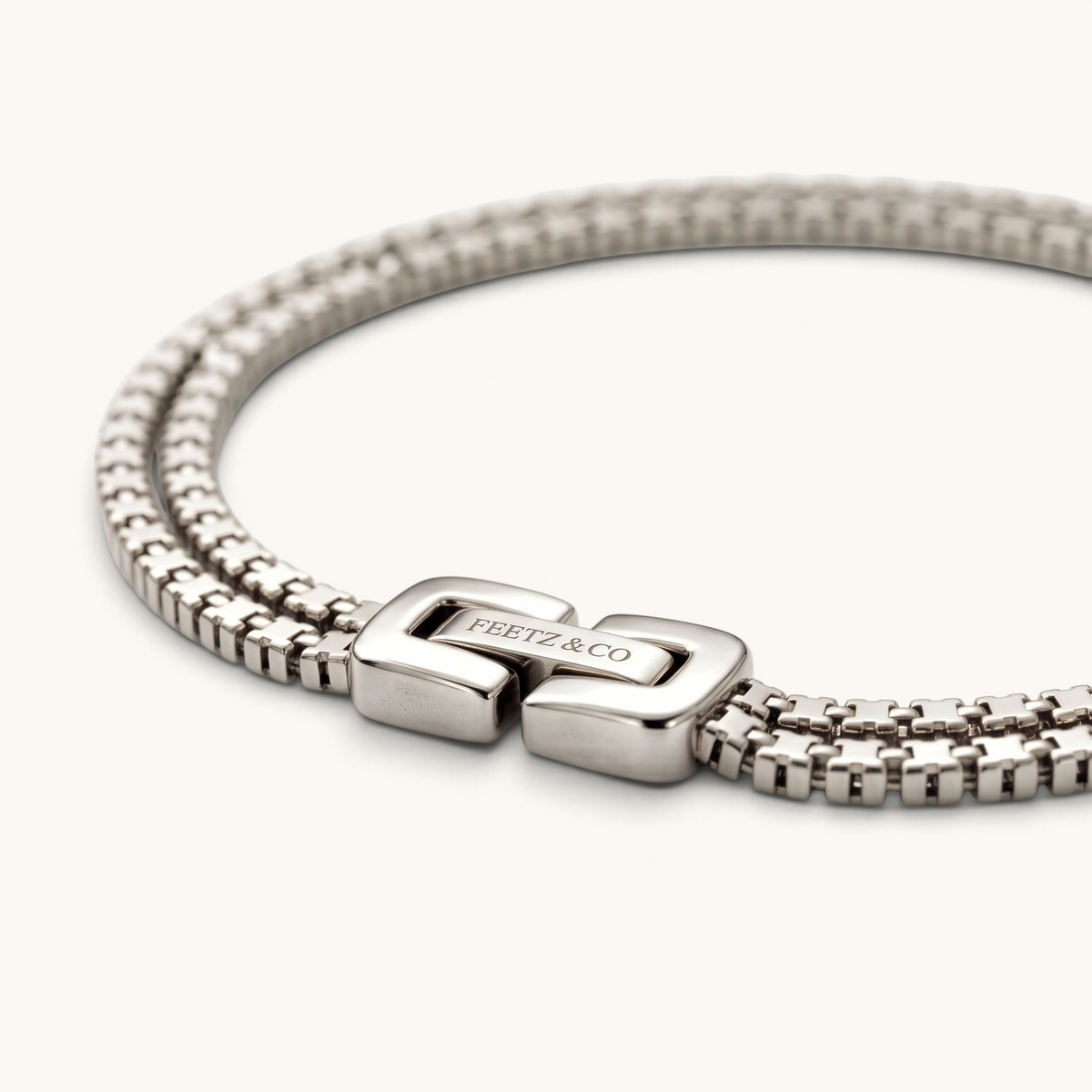 Feetz & Co. Rhea anklet featuring two rows of silver-plated stainless steel box links with a branded clasp.